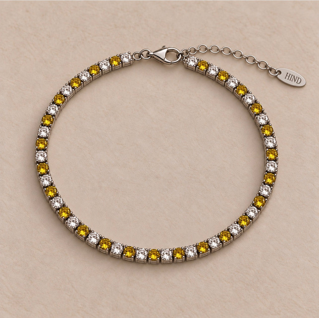 Bracelet Montou en argent 925, alternance de cristaux et de nano saphirs jaunes, avec fermoir et chaînette de réglage.