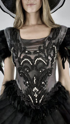 Detail of a black bodice embroidered with feathers