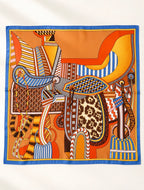 Foulard Rue des Barres déployé à plat, composition de sellerie orange et dorée, détails léopard et encadrement bleu.